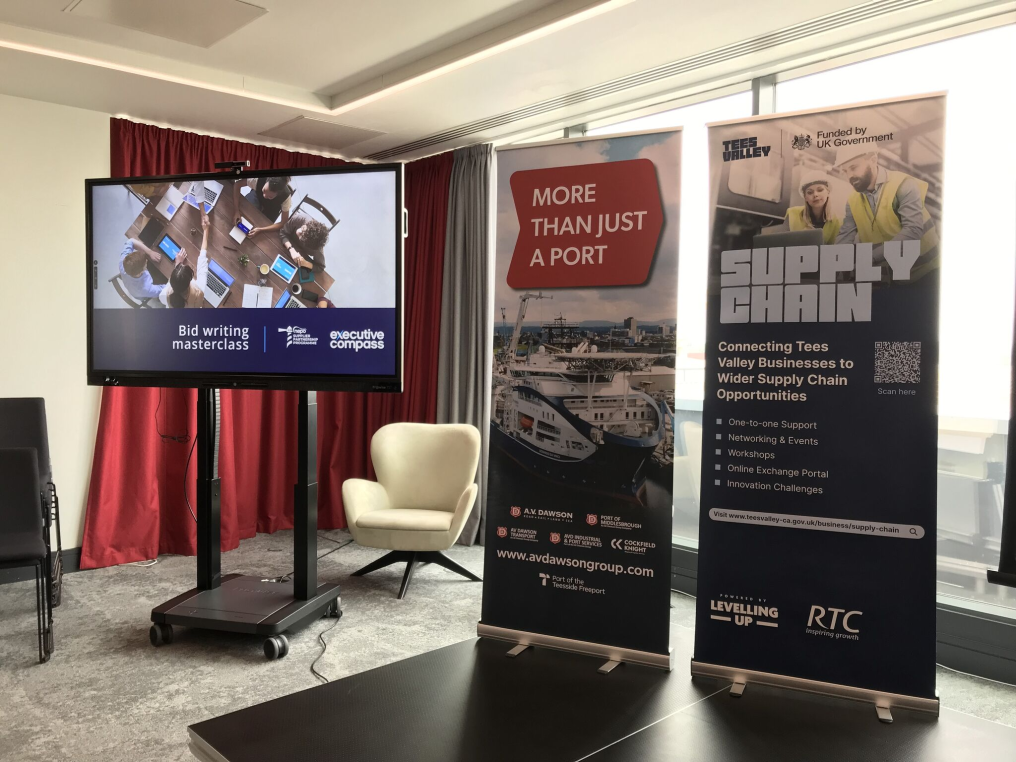 Bid writing masterclass stand, with a presentation on a tv