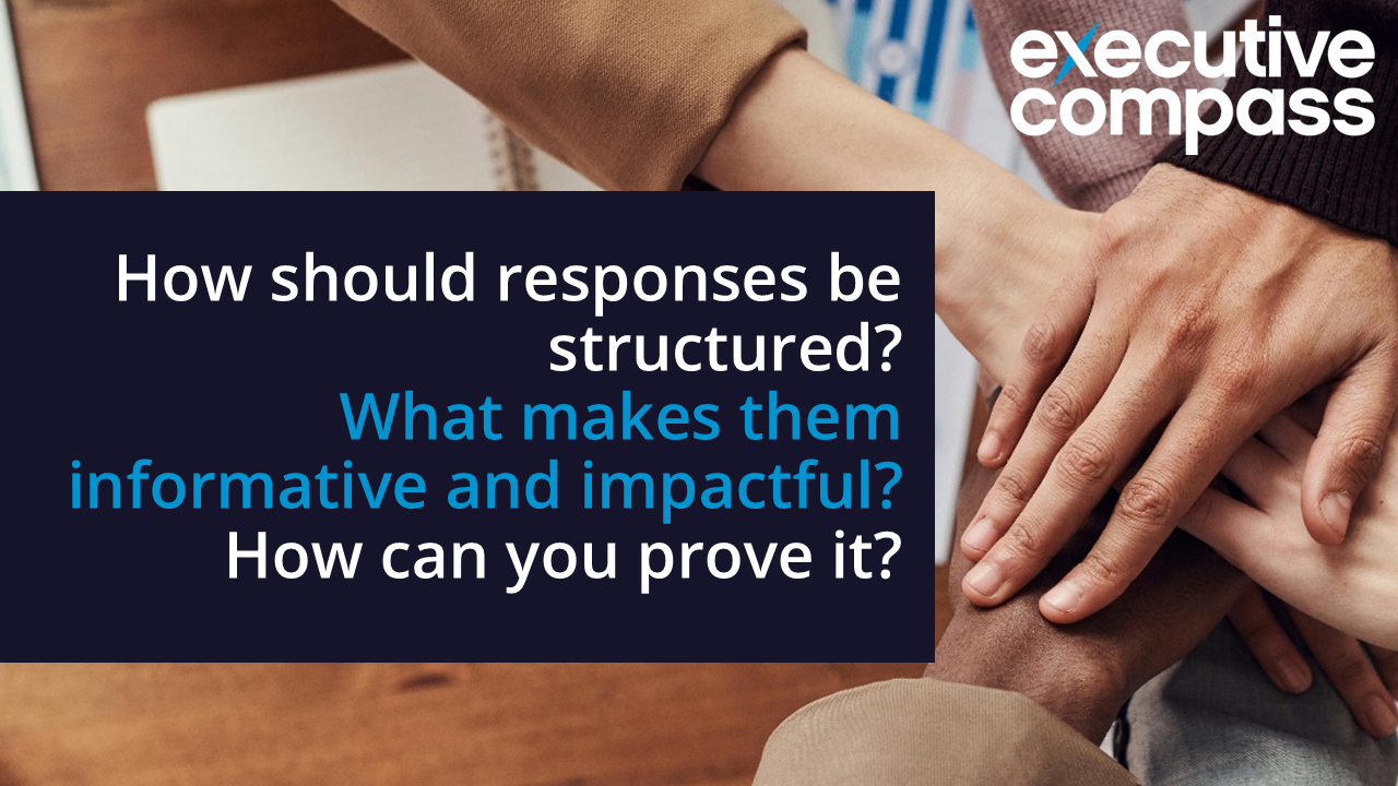 Hands stacked on a wooden table beside a dark box reading: 