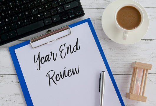 Image of Clipboard with "year end review" written on it