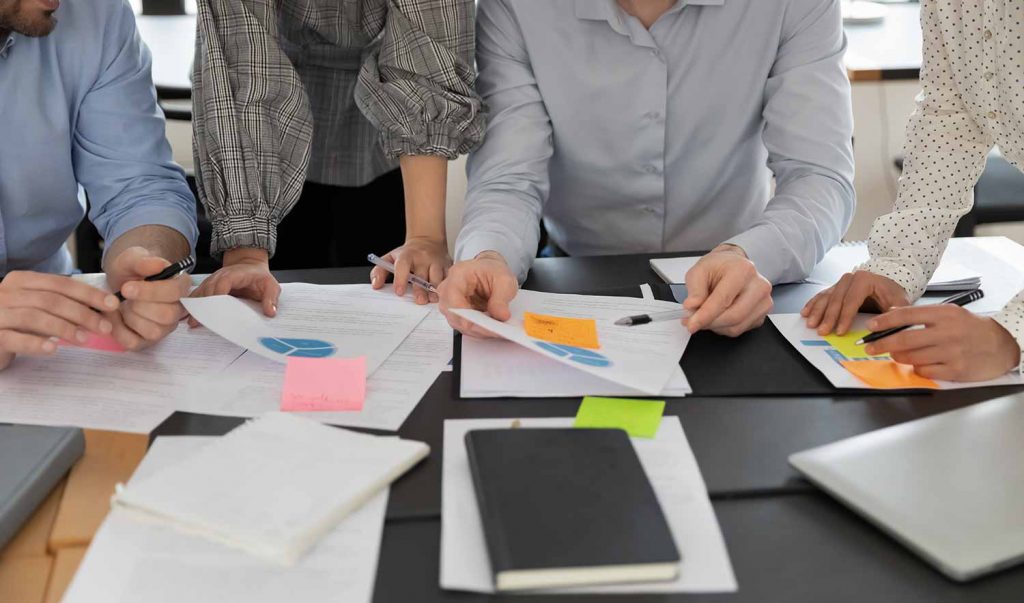 A group of people looking at various documents