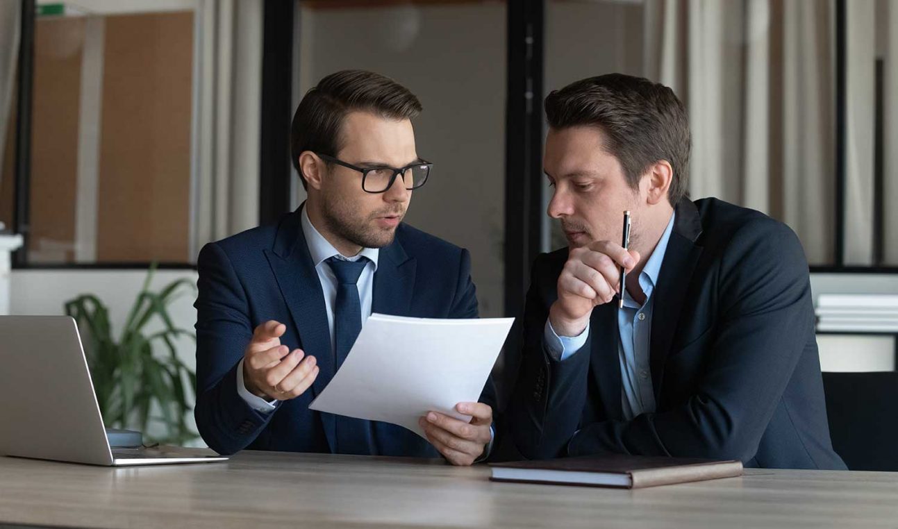 Two people looking at a paper document