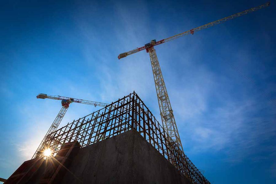 A crane standing tall above a building site