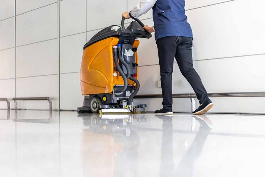 A heavy machine cleaning a white floor