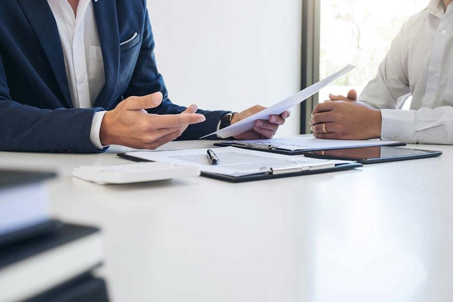 Two people discussing a document at a table