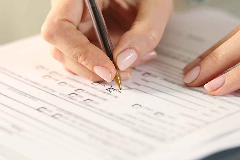 A person filling out a paper form