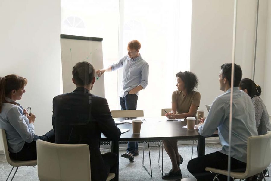 A person drawing on a flipchart whilst giving a presentation