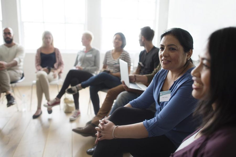 A group of people sitting on chairs