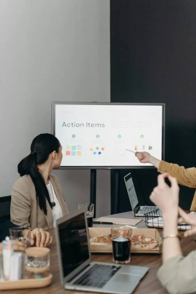 A person pointing at a television with a presentation on