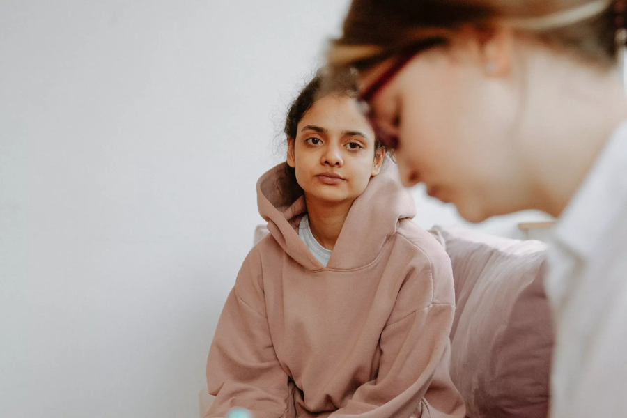 A person in a hoodie receiving support