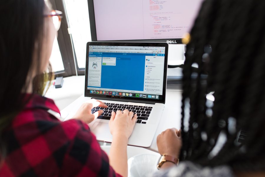 Two people looking at a laptop